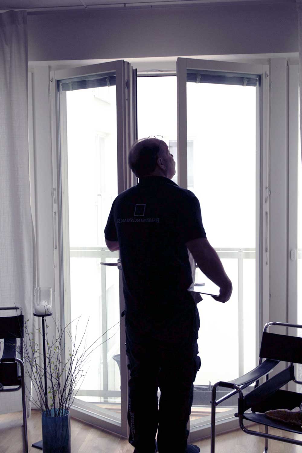 Besiktningsman besiktigar tak på ett hus och pekar på fel